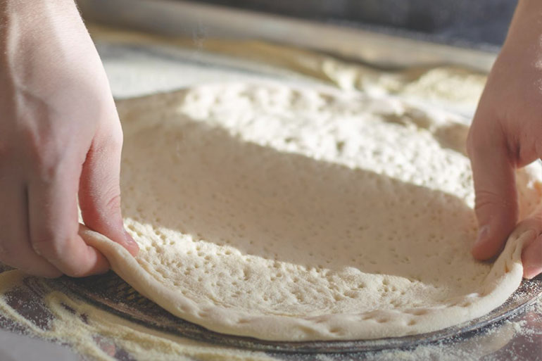 Chef kneading Hi Fibre Pizza Base