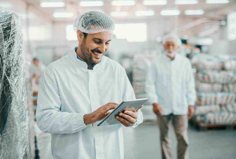 A man smiling looking at the ipad