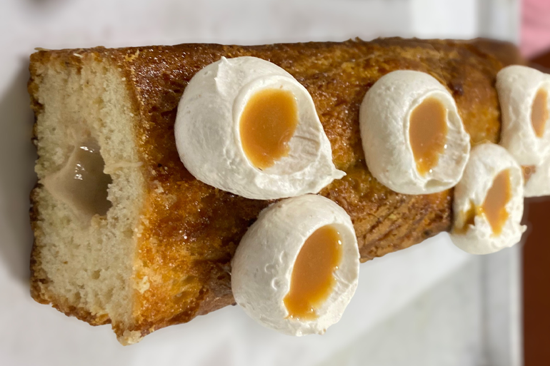 Banana jaggery cake topped with whipping cream