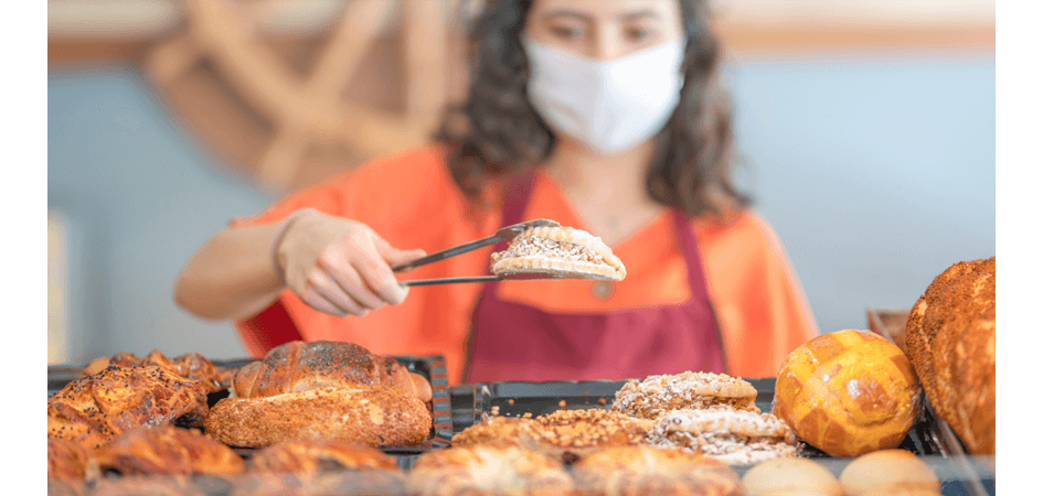 selller girl picking piece of bread