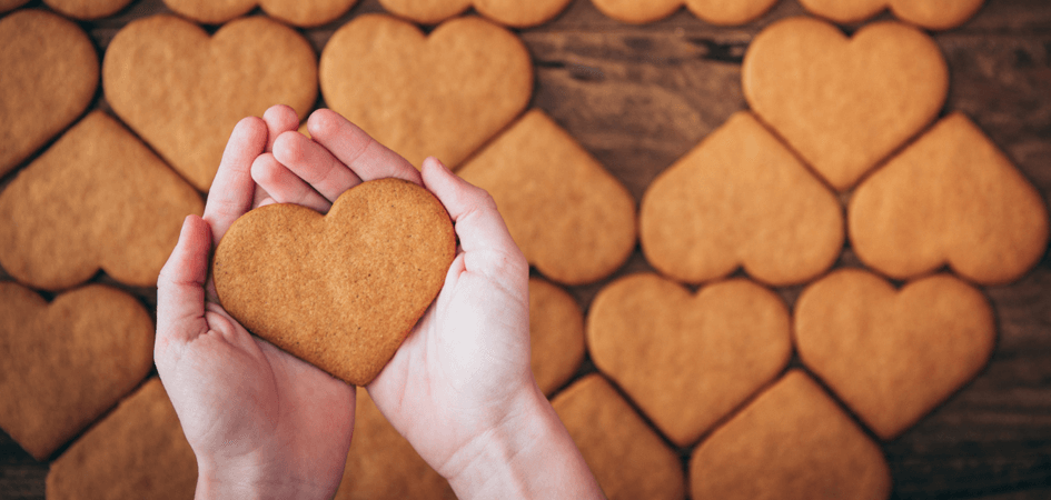 heart shaped cookie in hands